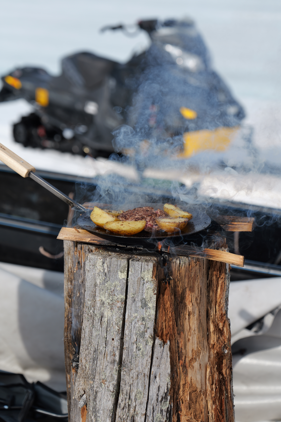 Cooking food over fire during a winter outing